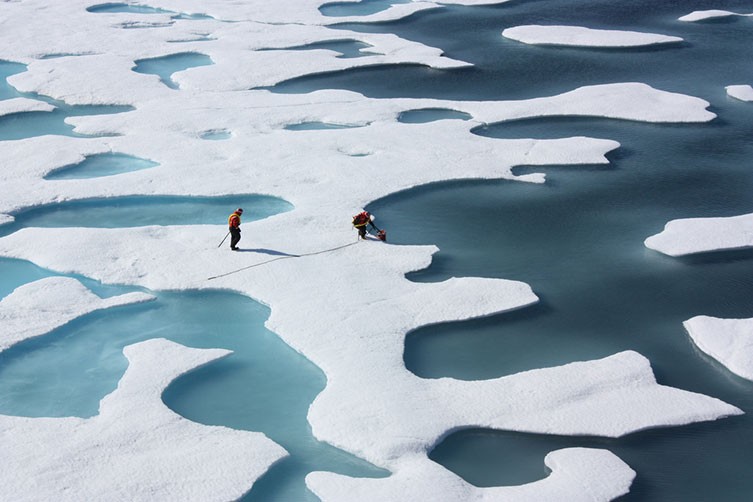 Scientists taking samples from patches of ice