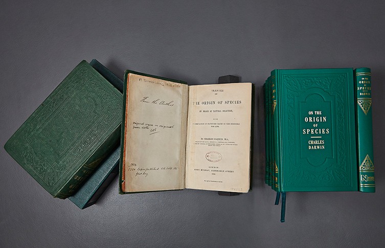 Original editions of Darwin's On the Origin of Species, alongside a modern facsimile