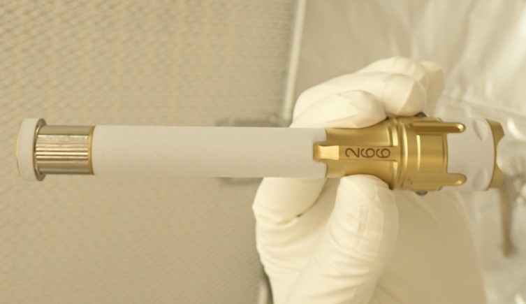 A gloved hand holds a sample tube