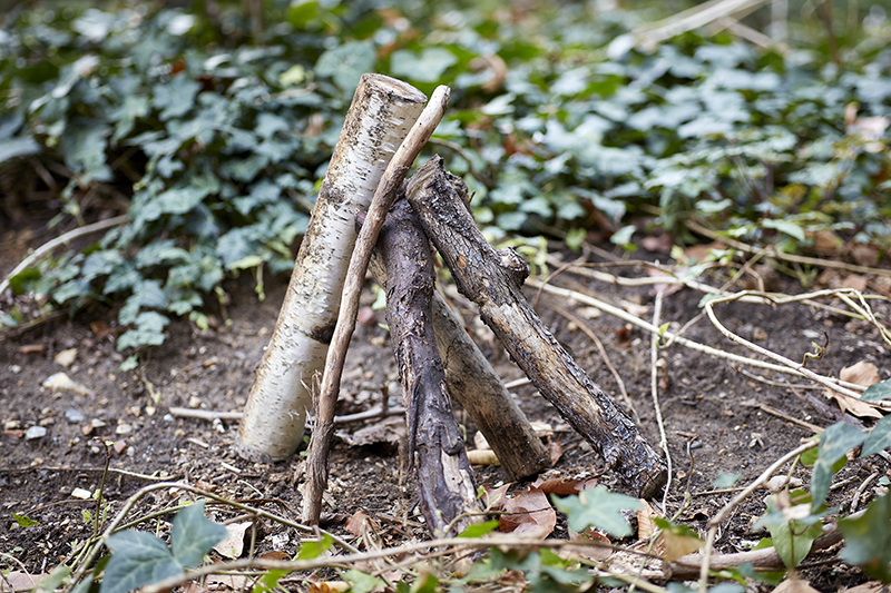five sticks leaning on each other