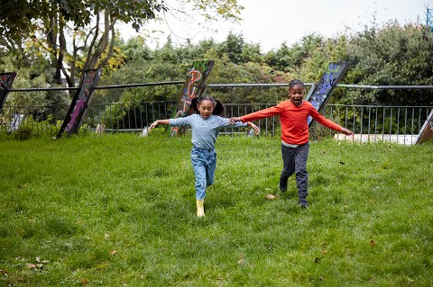 Two children run and flap their wings