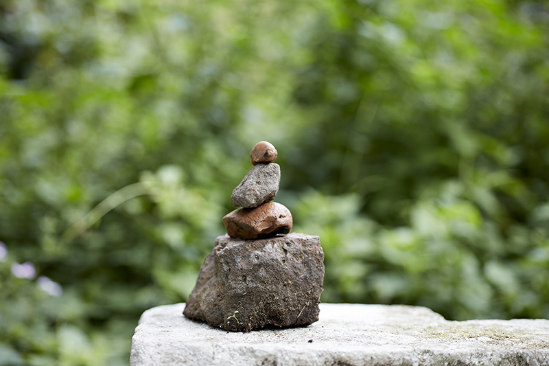 four rocks piled in a small tower